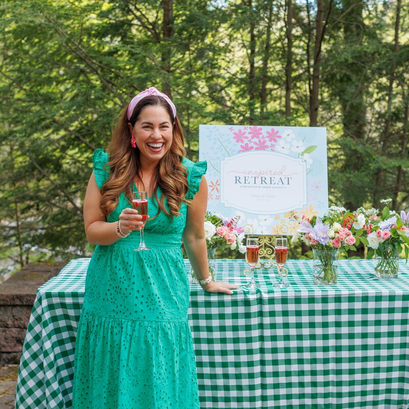 Amber Housley raising a glass at the Inspired Retreat welcome table
